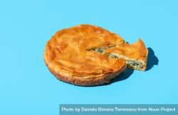 Phyllo spinach pie isolated on a blue background 0PpQm0