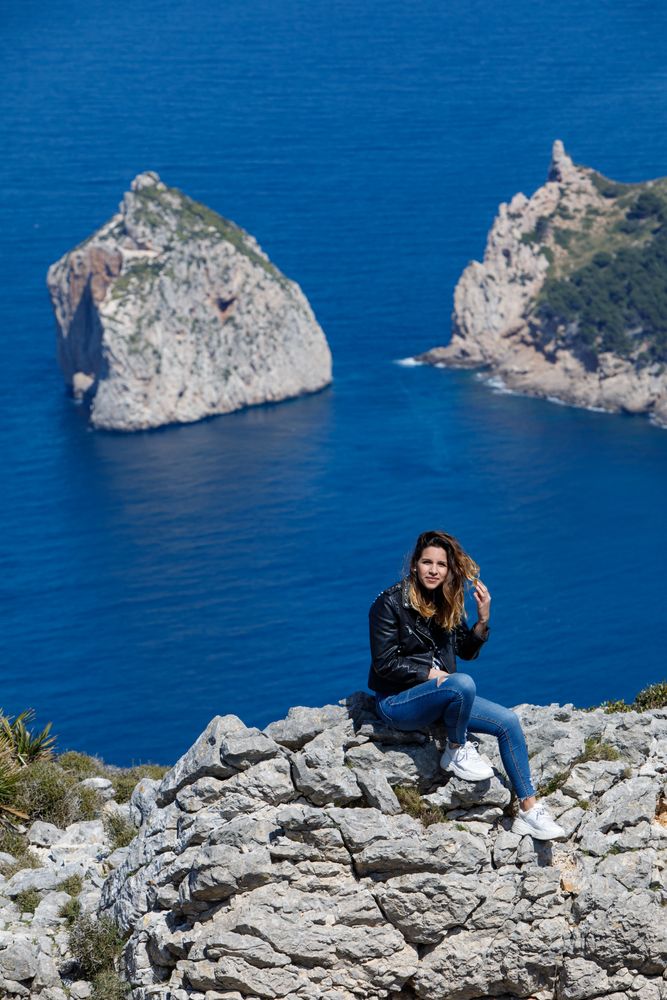 Young woman resting on cliff