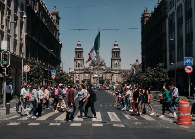 People walking across street in front of El Zocalo in Mexico City