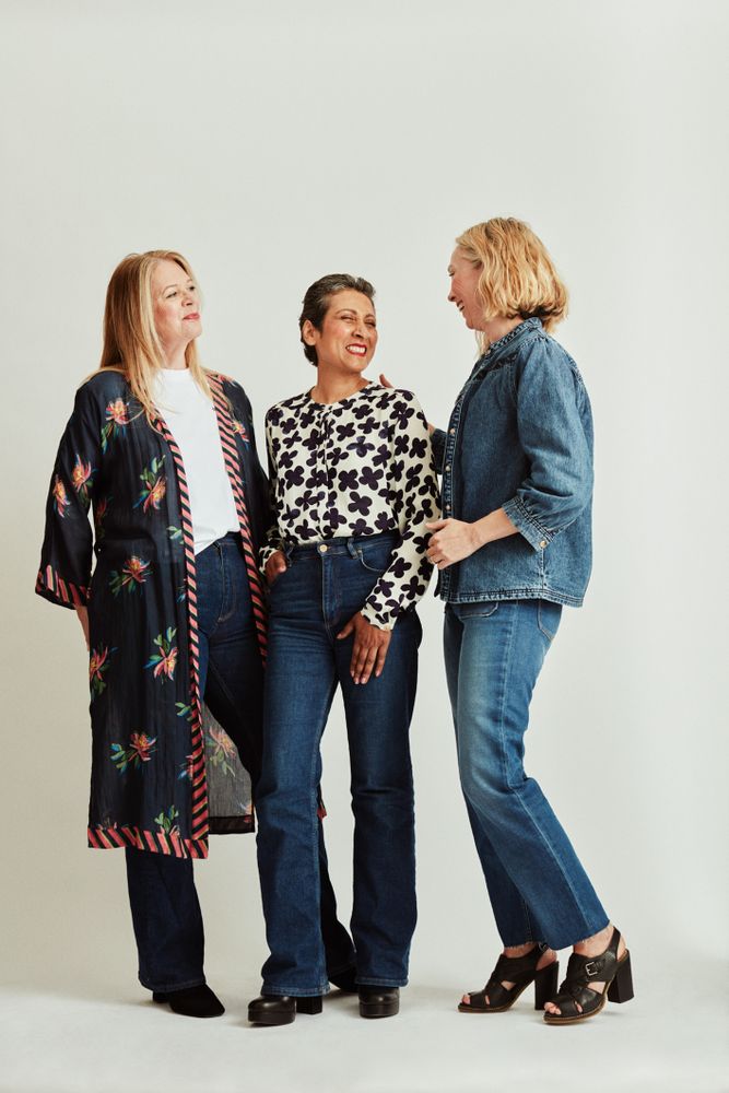 Three women standing together and smiling