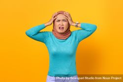 Disgusted Muslim woman with hands on her head bGw7Vb