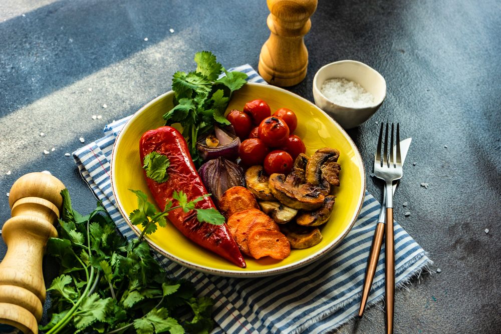 Plate of grilled vegetable on striped napkin with copy space