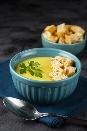 Bowl with onion soup and croutons on the table.