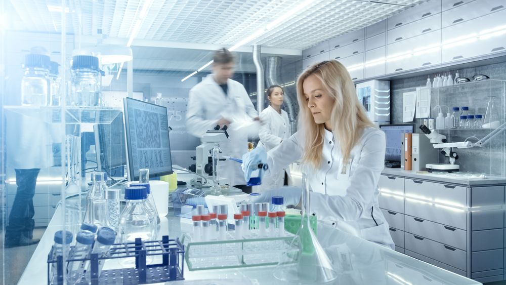 Team of Research Scientists Working With Personal Computer, Analysing Test Trial New Generation Drug Data.