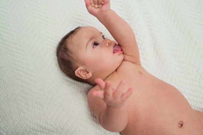 Portrait of cute baby boy with Down syndrome and his mother
