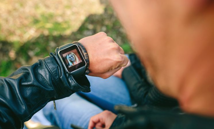 Unrecognizable man talking by videoconference with his smartwatch