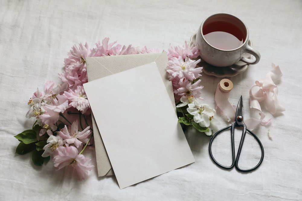 Blank greeting card invitation with coffee and flowers