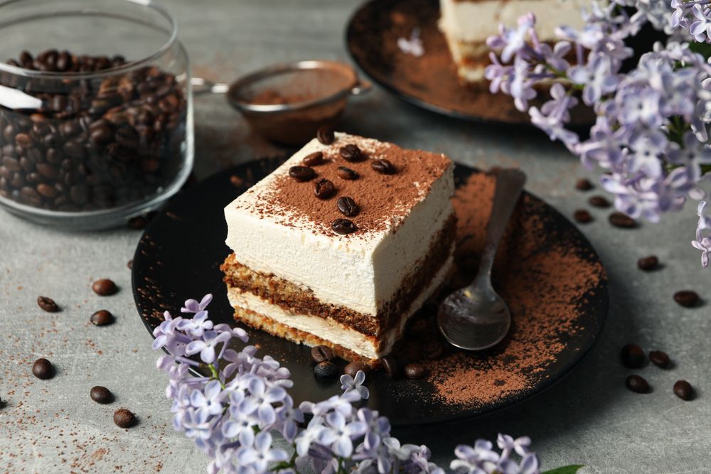 Composition with tasty tiramisu and lilac. Delicious dessert