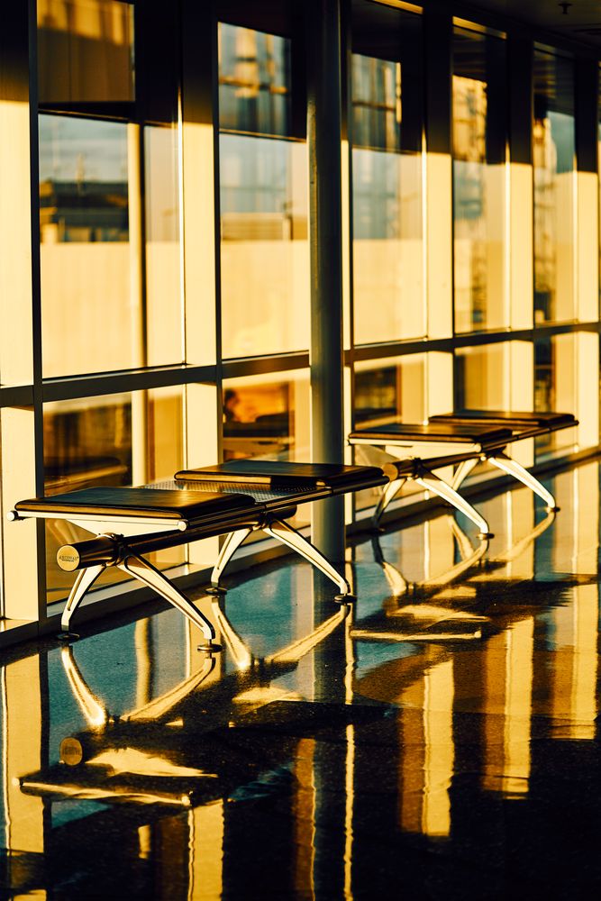 Long bench with soft seat nearby glass wall