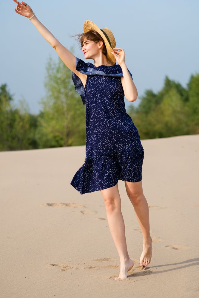 Romantic woman walking on sandy dunes