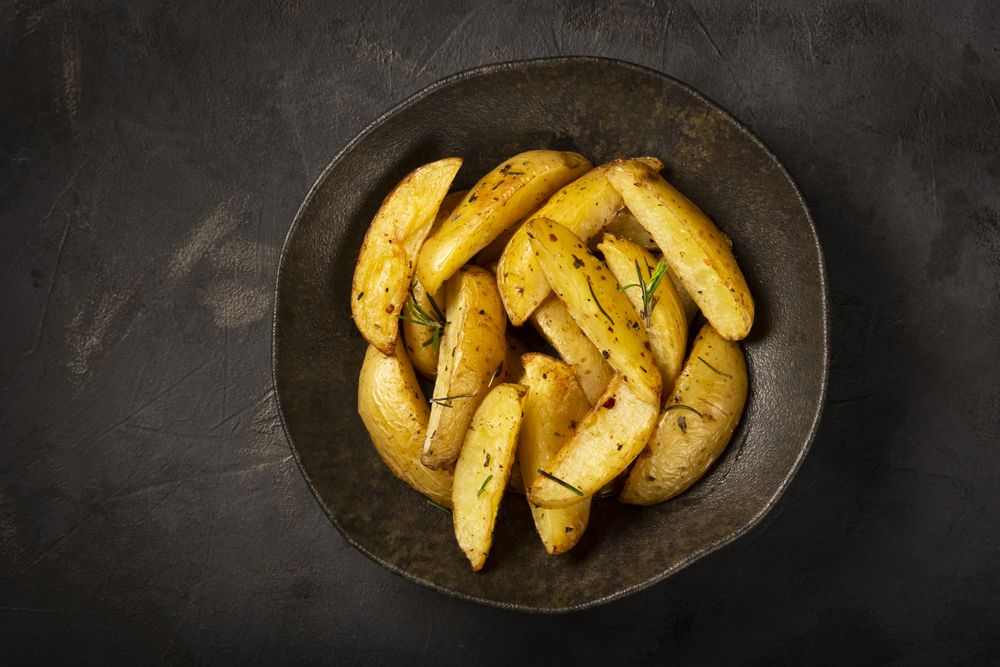 Roasted potatoes with rosemary on the plate.