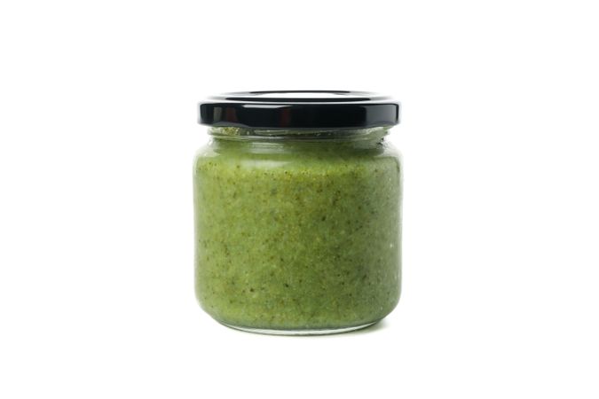 Glass jar with healthy baby food isolated on plain background