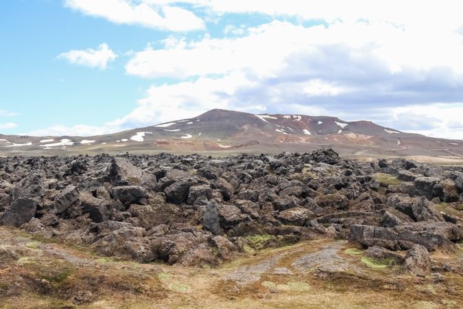 Leirhnjúkur volcano showing solidified lava and patches of snow in iceland