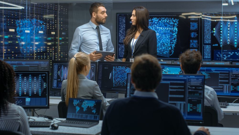 Head of the Department and Project Manager Discuss Work Process Using Data on Tablet Computer.