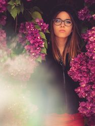 Woman on background of stunning violet flowers