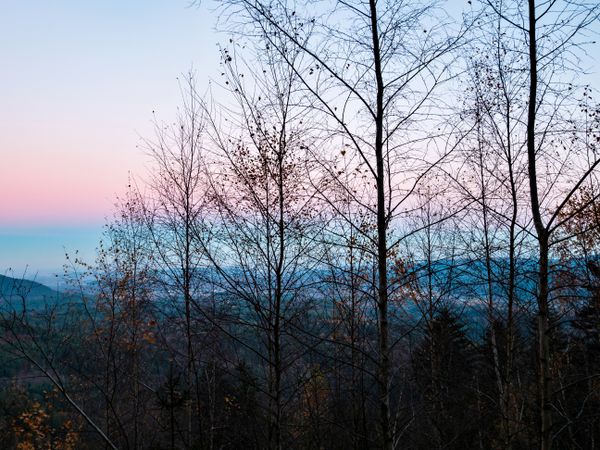 Snow and blue sky. Panoramic view of the silhouettes of the mountains.