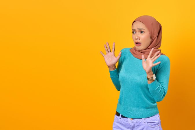 Frightened Muslim woman with copy space