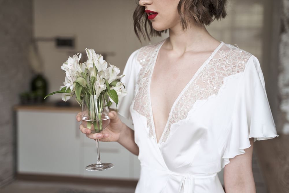 woman with red lips holding white flowers and dreaming