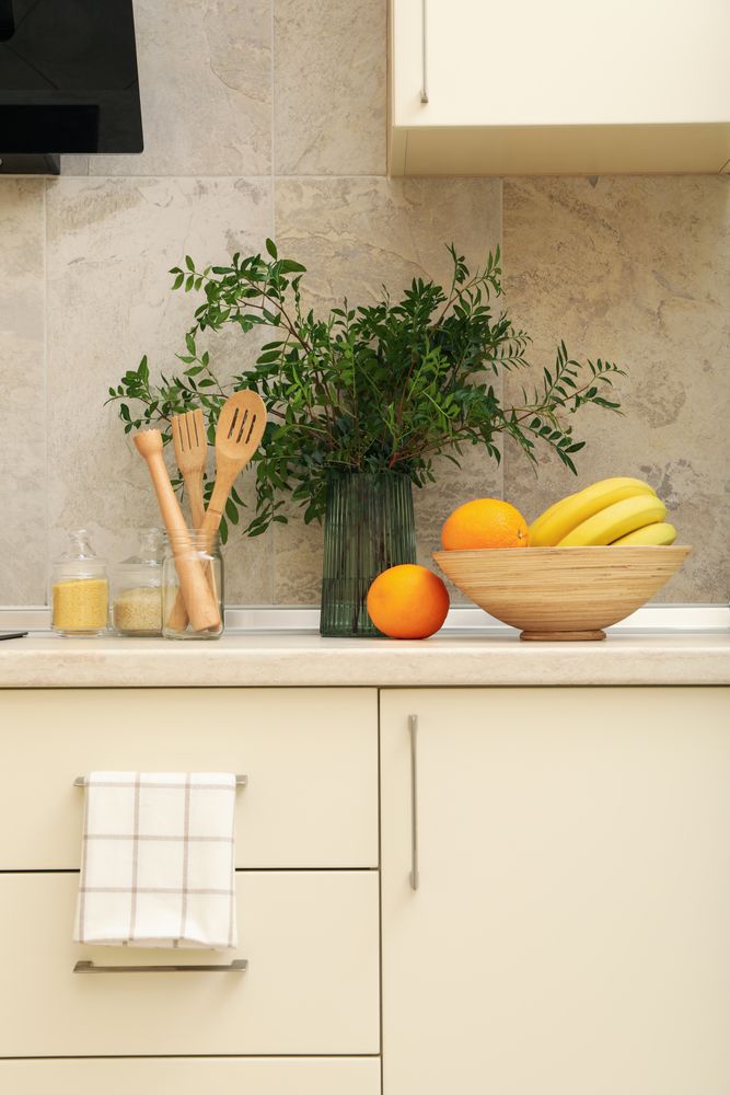 Modern kitchen interior with different supplies in light colors