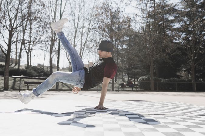 Man dancing break dance in park