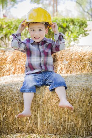 Young Boy Laughing with Hard Hat Outside