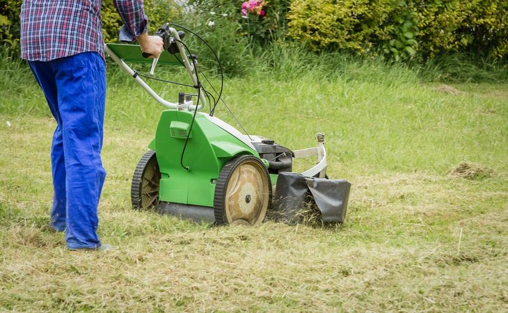 man mowing the lawn with a lawnmower