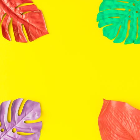Painted tropical and palm leaves in vibrant bold colors on yellow background