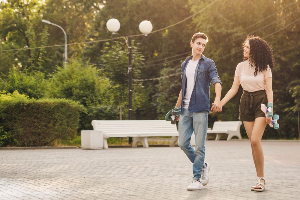 Teenagers with skateboards in the city park