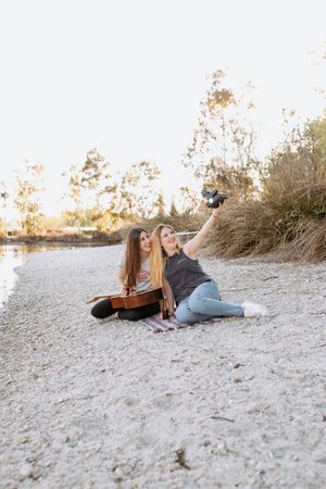 Girl friends taking selfie on beach