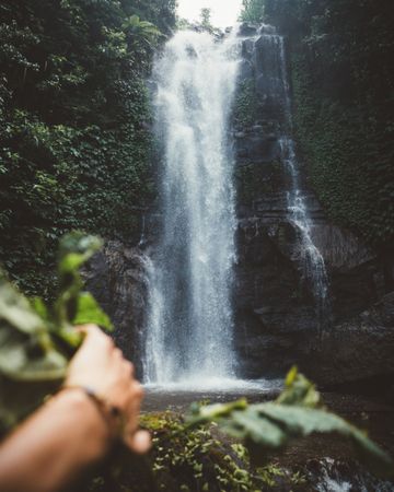 Traveler exploring amazing waterfall in jungles
