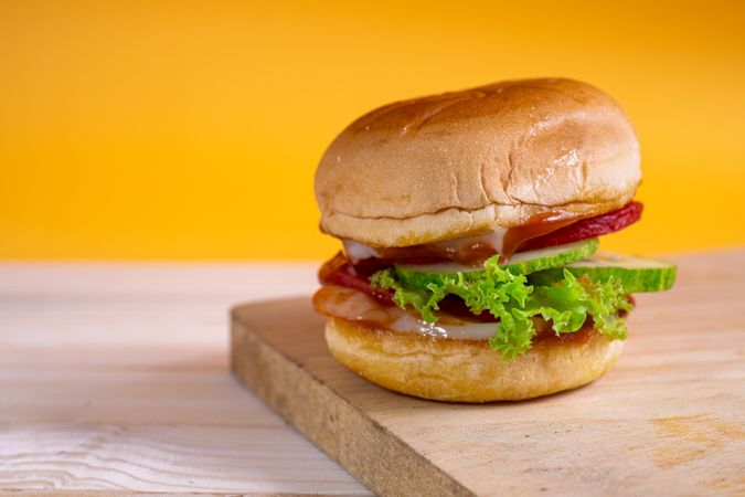 A sandwich with lettuce and tomato on top of a bun
