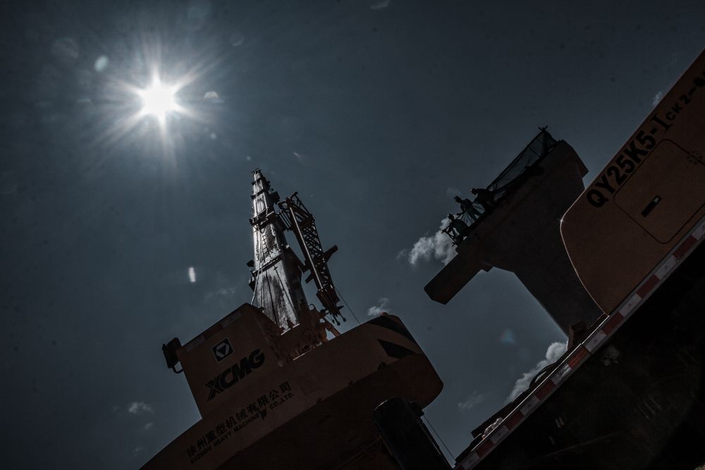 Low angle view of crane at sunset