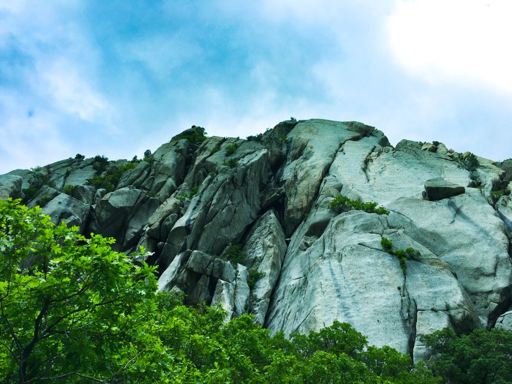 Gray rocky mountain under blue sky