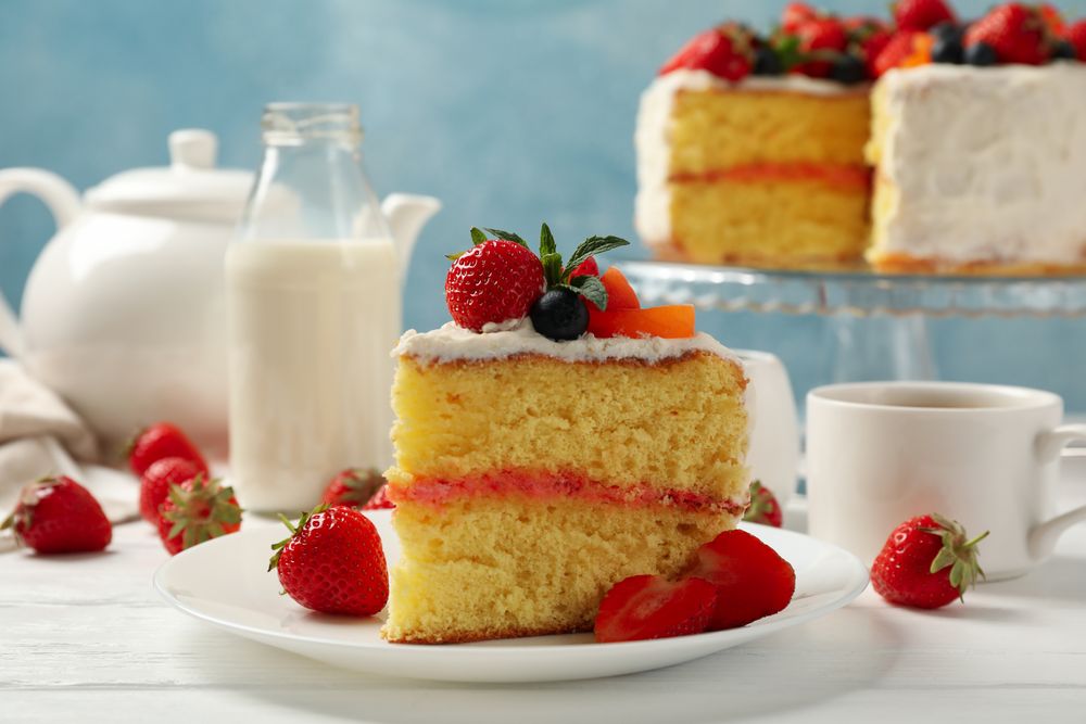 Composition with delicious berry cream cake on wooden table. Tasty dessert