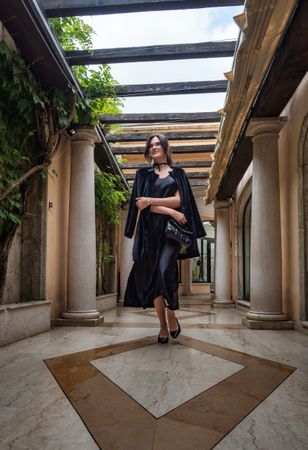 A woman in a gorgeous dress walks gracefully through the gallery