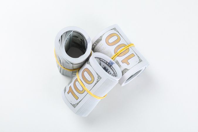 Stacks of American cash money, isolated on light background