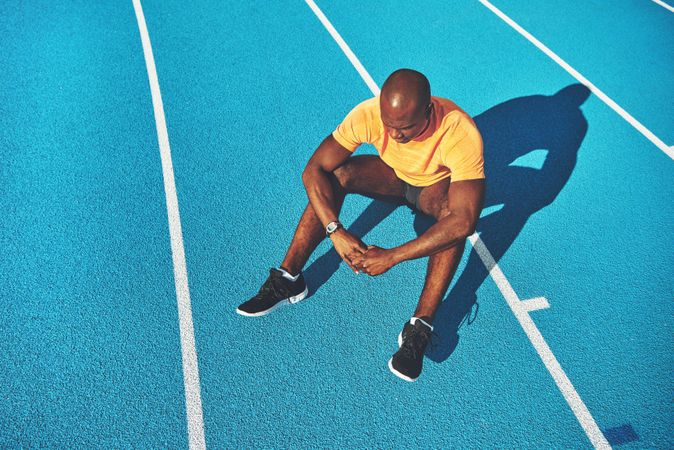 Athlete sitting on race course after work out