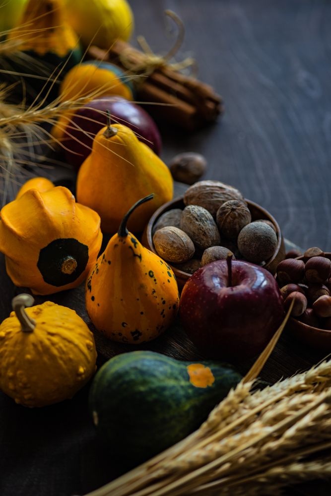 Autumnal foods on wooden table with space for text