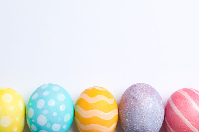 Decorative Easter eggs on neutral background, space for text. Top view