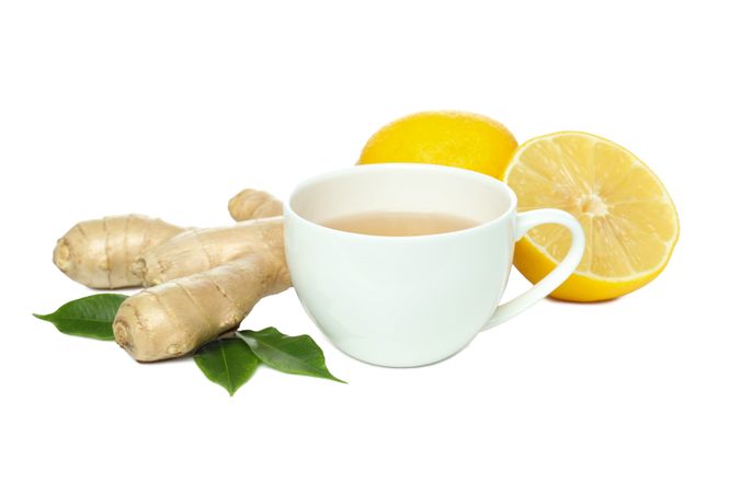 Cup of tea, ginger and lemon, isolated on plain background