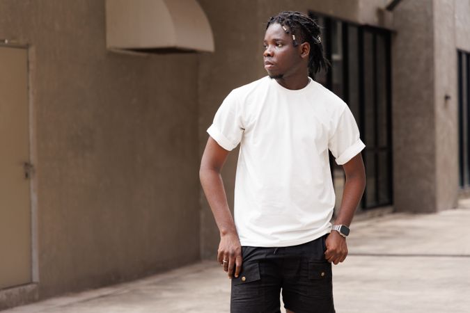 Man in t-shirt outside with concrete background