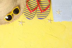 Summer vacation accessories on color background, space for text and top view. Happy holidays