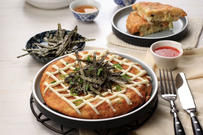 Japanase Okonomiyaki, Served on Ceramic Plate with Tea