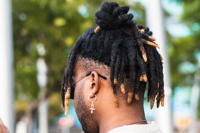Modern male with dreadlocks and in accessories