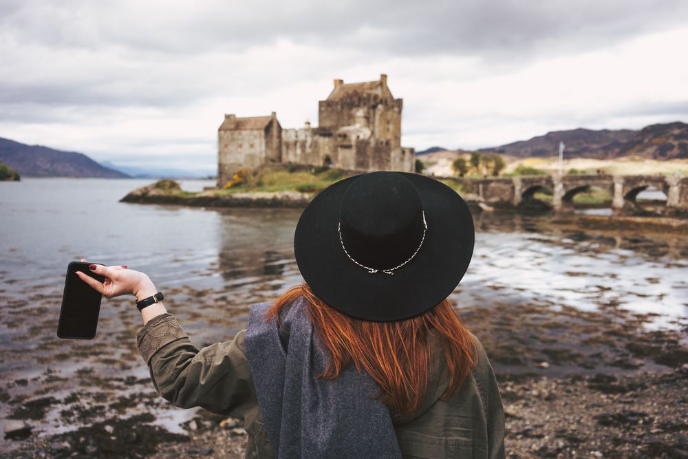 Woman contemplating castle landscape