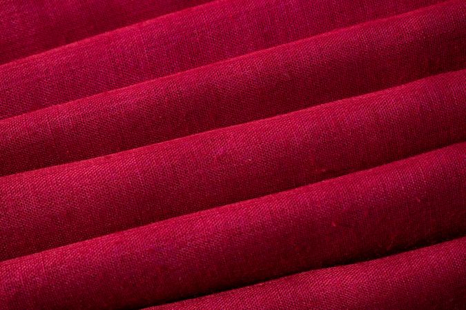 Close up Red fabric folded background texture.