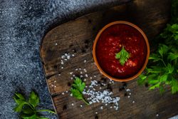 Top view of traditional Georgian sauce on cutting board- satsebeli with parsley garnish