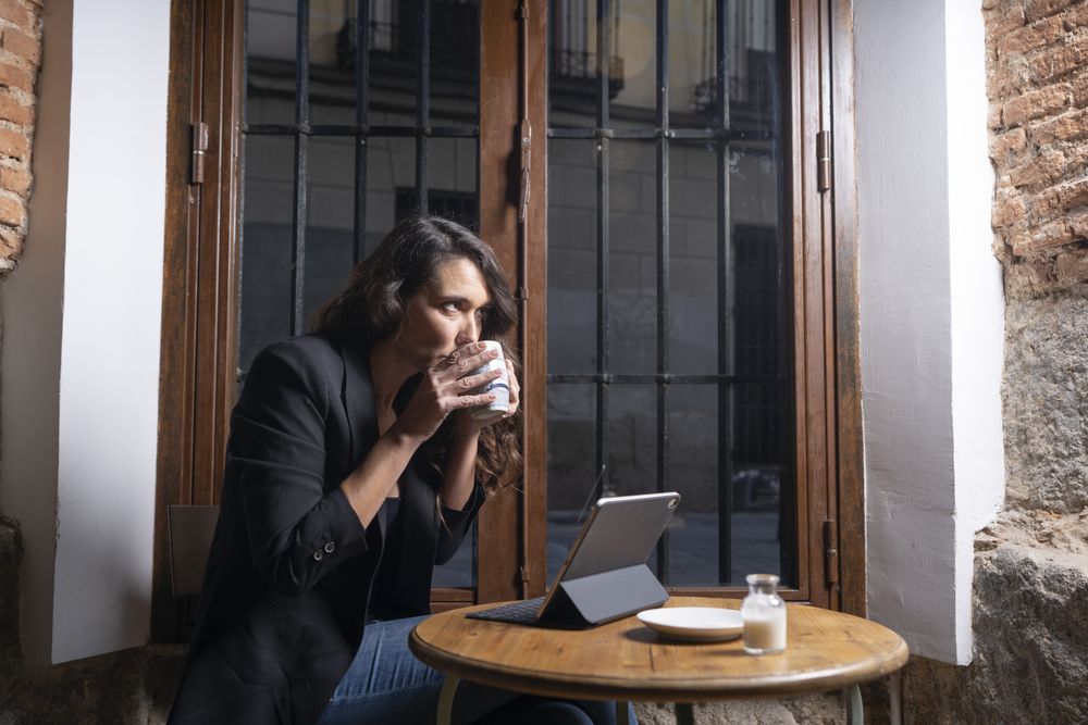 Young female using digital tablet in cafe