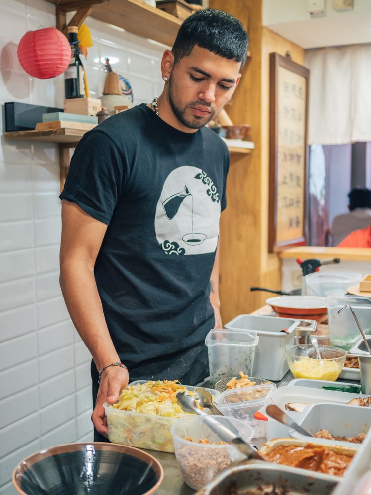 Young male working in Asian cafe