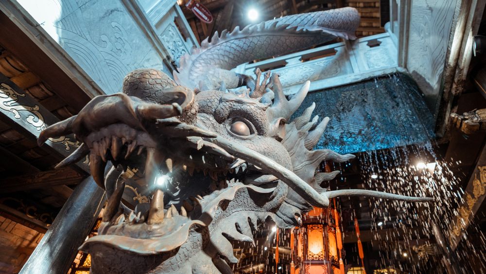 Close-up shot of gray dragon statue inside building